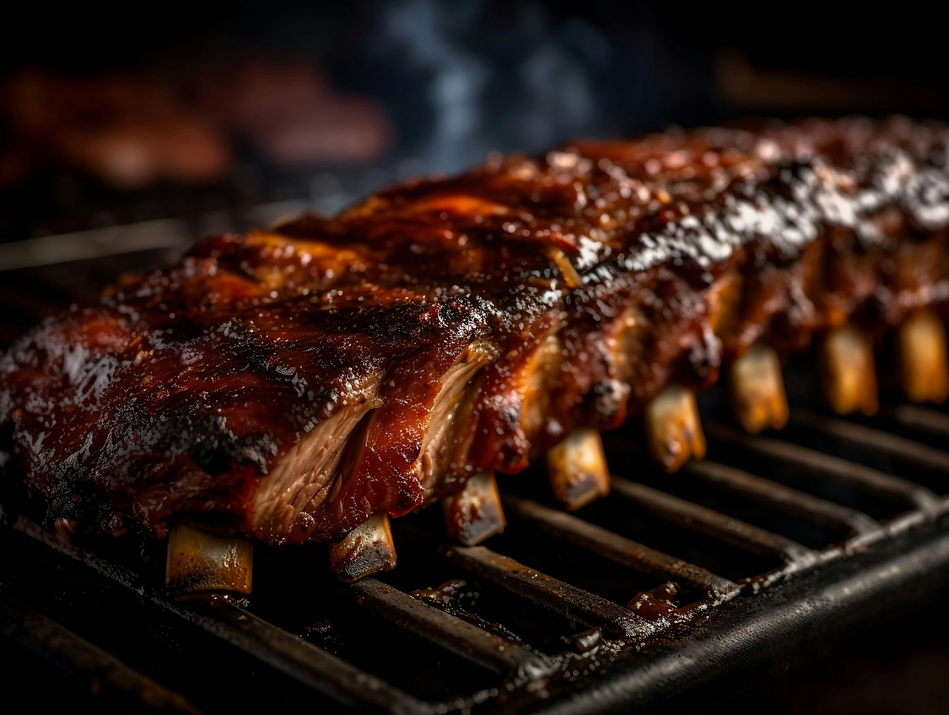 a rack of ribs cooking on a grill